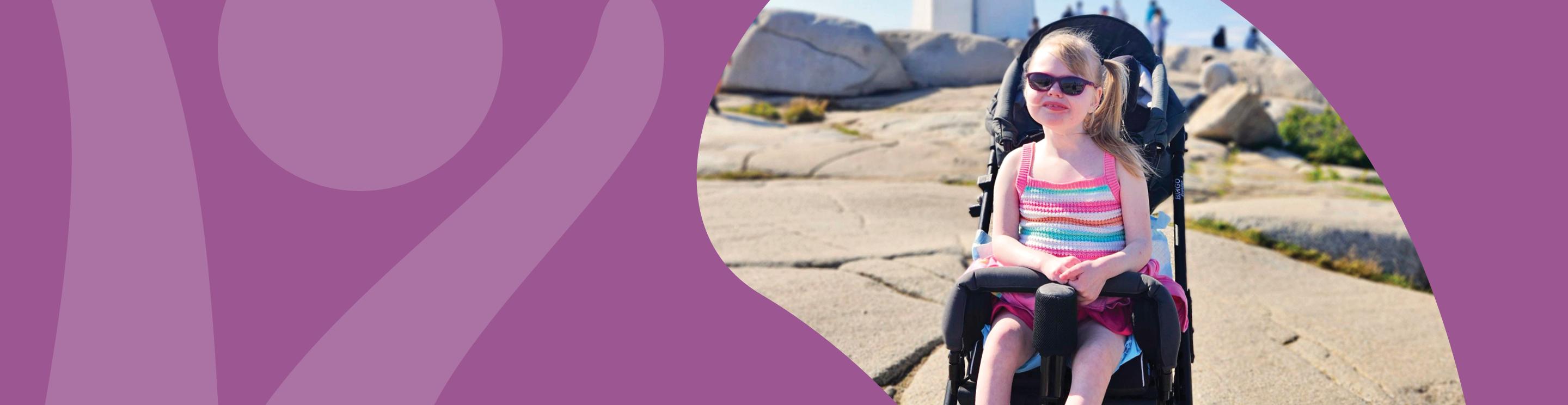 Lyla smiling at the camera with a lighthouse in the background