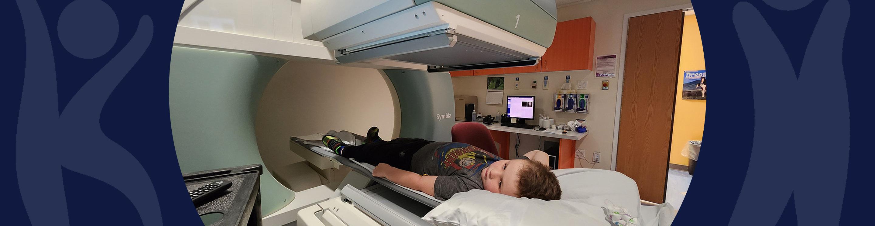 Jonas, an IWK patient, laying on a table to have an x-ray 