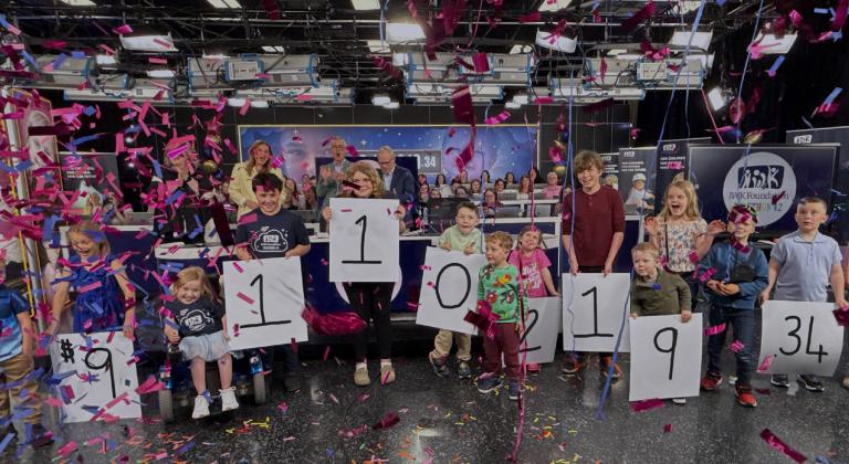 Children holding numbers to announce the fundraising total for the IWK Telethon for Children