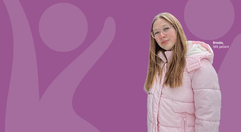 Brooke, an IWK patient, smiling while wearing a light pink winter jacket.