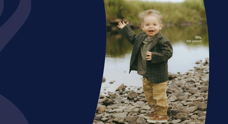 Ellis smiling while standing on rocks.