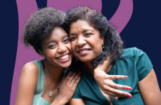 Two smiling women hugging.