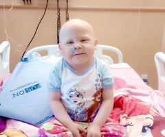 Alycia, IWK patient, sitting on her hospital bed at the IWK.