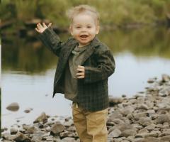 Portraits of Ellis and his family enjoying time together in a park.